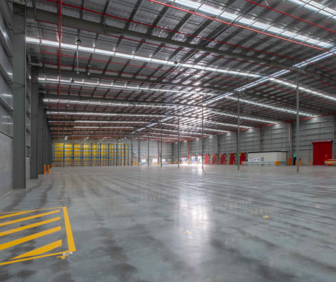 image of a large empty warehouse with shiny cement floors