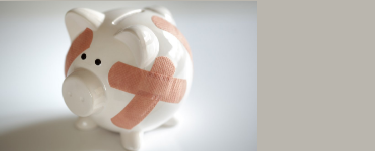 piggy bank with bandaids illustrating how to lower your debt-to-income-ratio