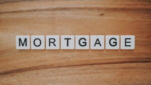 brown wooden background with scrabble tiles spelling out the word mortgage for what happens when your fixed rate mortgage expires 