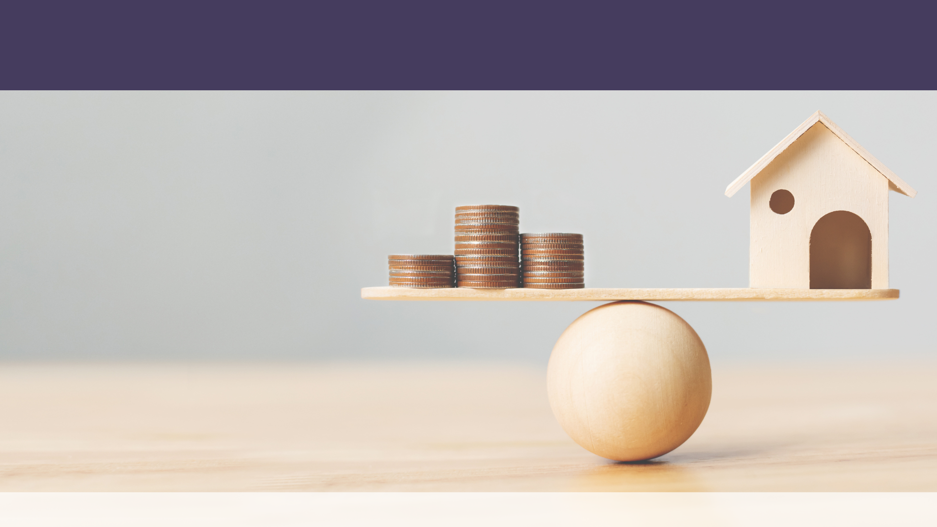 wooden table with a wooden ball with wooden lever balanced on top, one side holding coins and the other side a small wooden house for benefits of refinancing