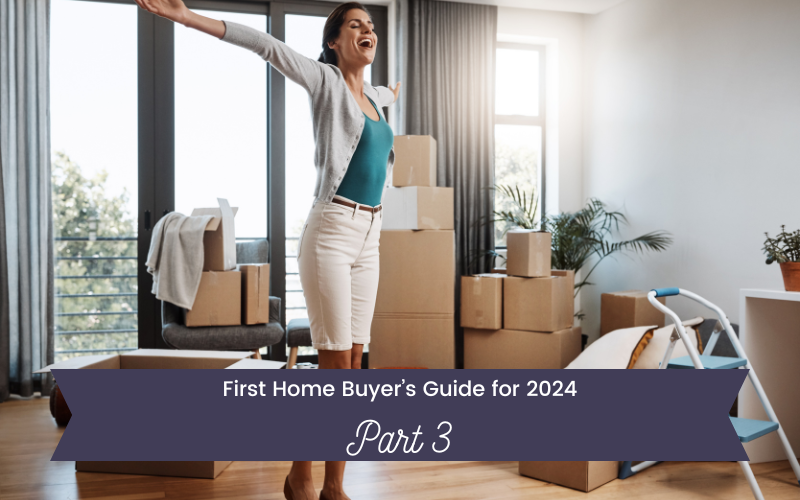 fist home buyer jumping up in her living room arms thrown wide with moving boxes all around for guide for first time home buyers