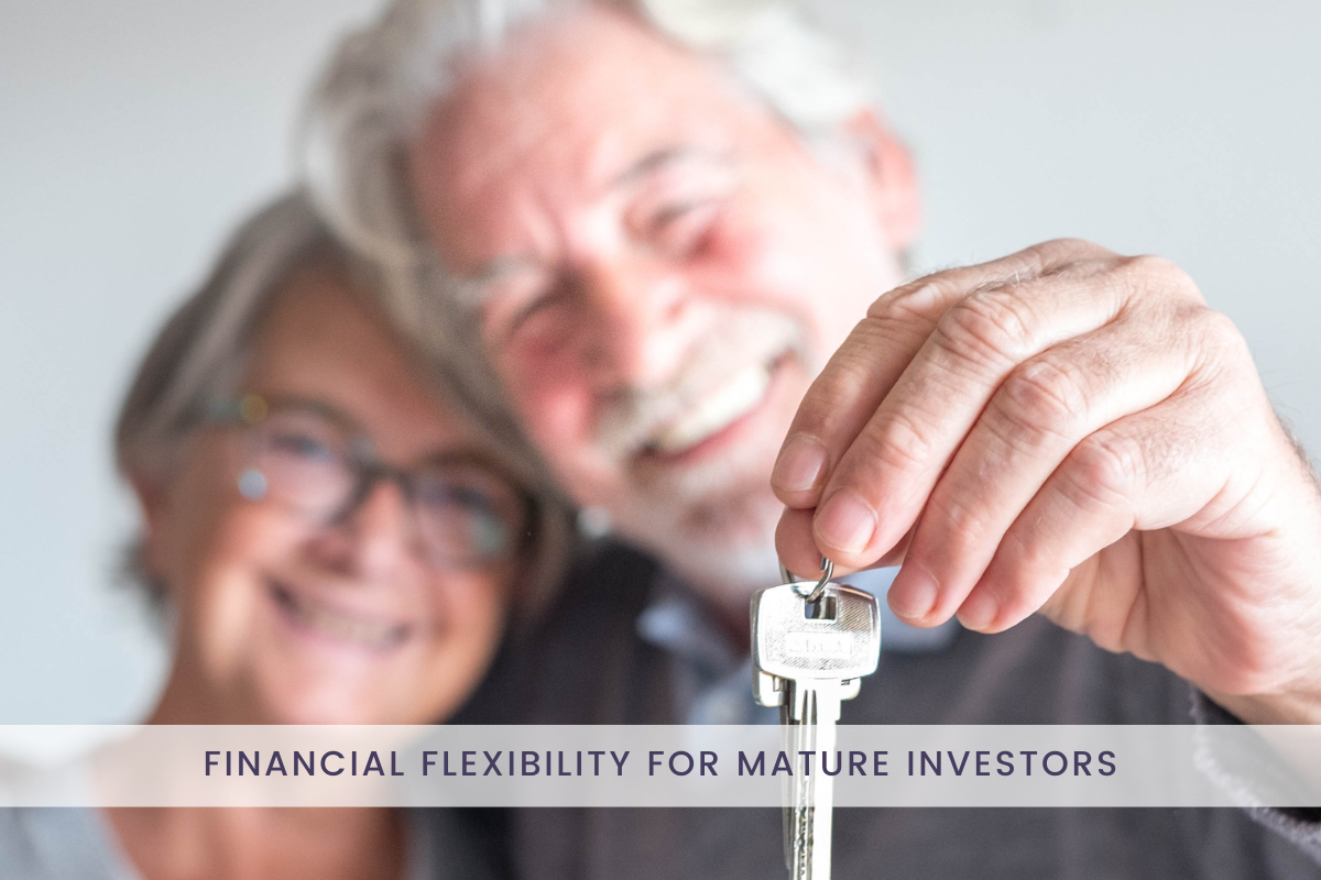 mature age borrowers who are investing over 50 for financial flexibility smiling into the camera and holding a silver house key