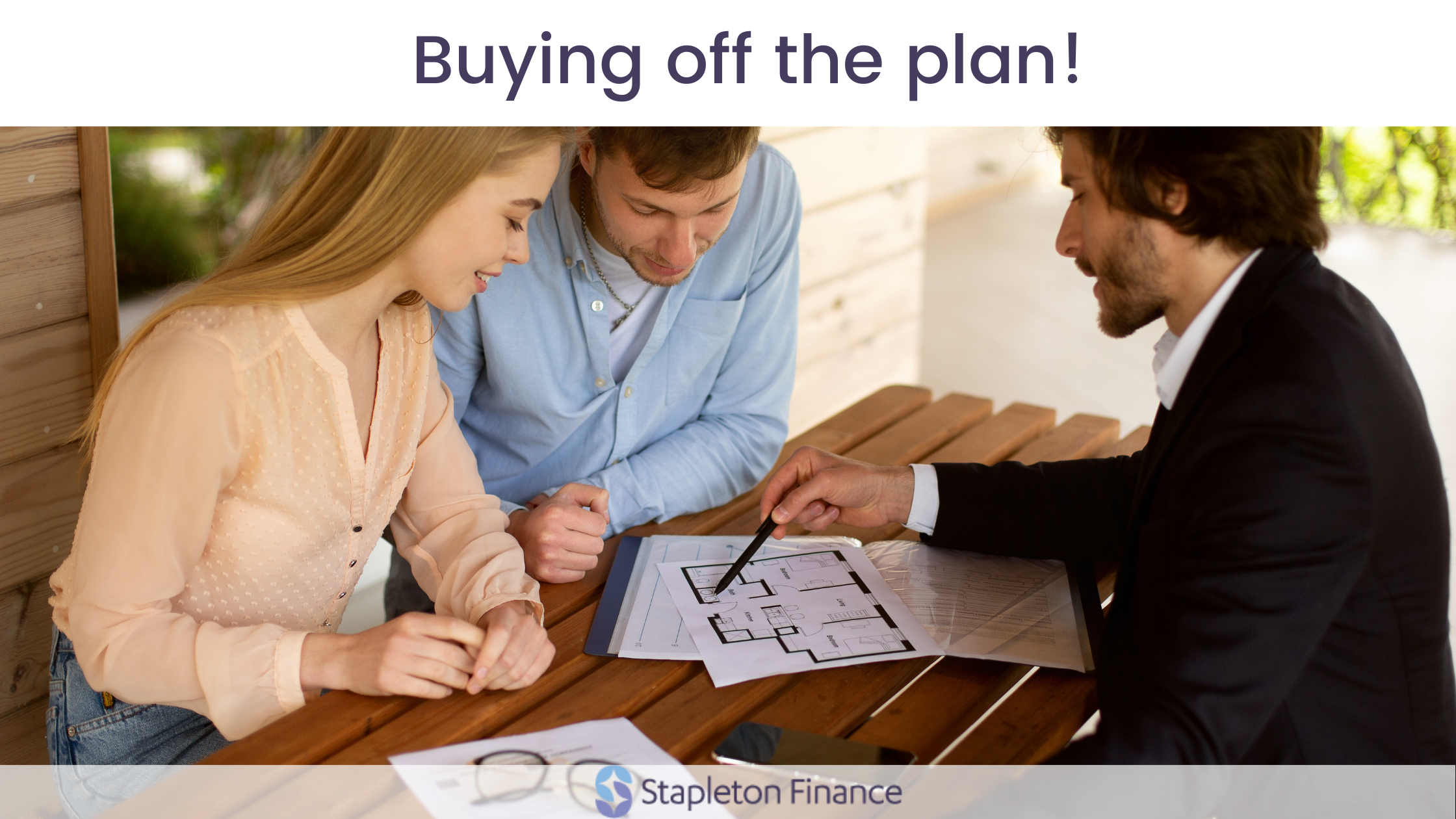 couple looking over plans with a builder or lawyer on a wooden table with buying off the plan graphic above