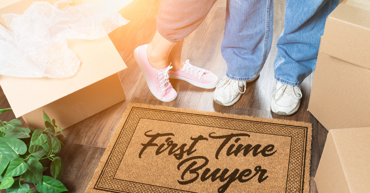 image of buyers feet in sneakers and jeans next to a mat that says first time buyer for the first home guarantee scheme qld