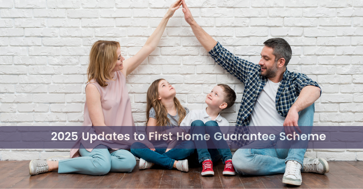 A family sits against a white brick wall, with mom and dad touching fingers in a V-shape over the heads of their children, a boy and a girl, showcasing updates to the first home guarantee 2025
