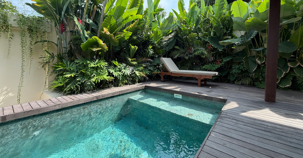 pool with tropical plants surrounding it and a lounge chair showcasing lifestyle features you have to budget for as a first time home buyer